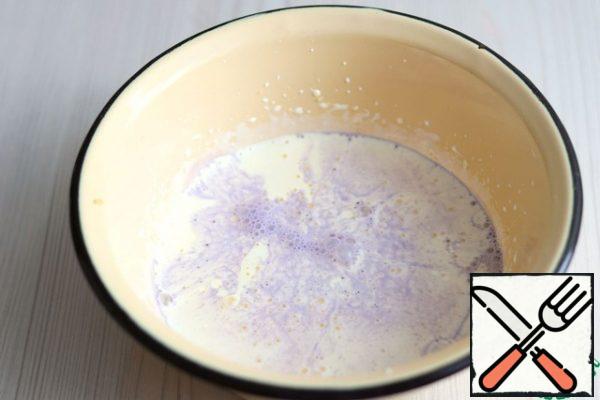 Next, pour a thin stream of creamy lavender base into the whipped yolks. Mix until well blended. Return the ice cream container to a low heat and thicken slightly with constant stirring. Do not boil!