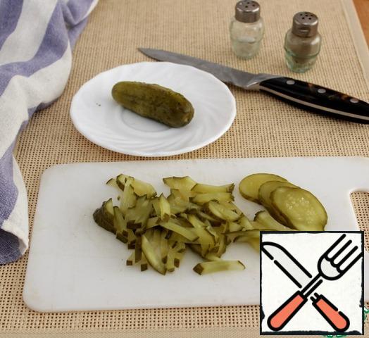 Cut the pickle into strips.