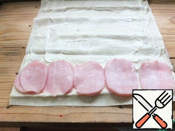 Lavash leaf smeared with a small amount of mayonnaise, spread half the ham.
In fact, lean pork, beef, and chicken will fit perfectly here. In the quality of a fresh Supplement, you can put lettuce leaves.