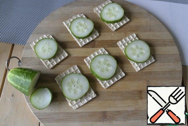 Cucumber cut into thin washers, put on top of the loaves.