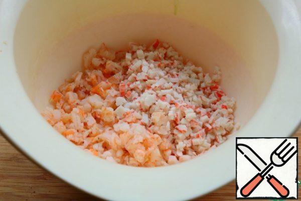 Very finely chop the shrimp and crab sticks.