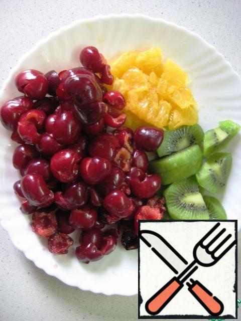 Pour water into a saucepan, add sugar and bring to a boil over a low heat, so that the sugar is completely dissolved. Immediately remove from the heat and allow to cool.Wash the fruit. Peel and slice the kiwi. Remove the seeds from the cherries. Peel half an orange and remove all the film so that only the flesh remains.