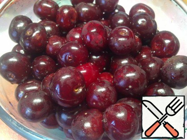 While the syrup cools, prepare the cherries. We sort and remove the spoiled berries, wash them and put them in a colander to drain the water.