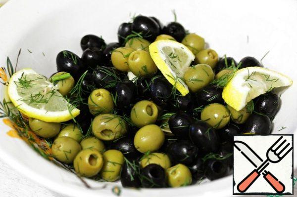 Put the olives in a deep bowl, add the dill, garlic and lemons.