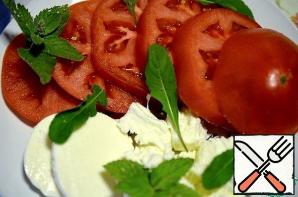 Pour the dressing over each slice of tomato and mozzarella. Season with salt and pepper.