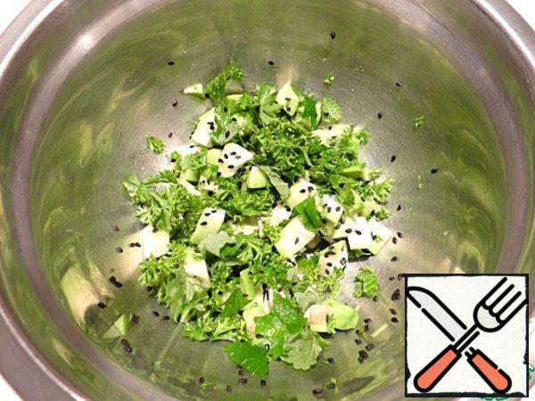 In a bowl, combine avocado, parsley, Melissa, and black sesame. Carefully mix the ingredients.