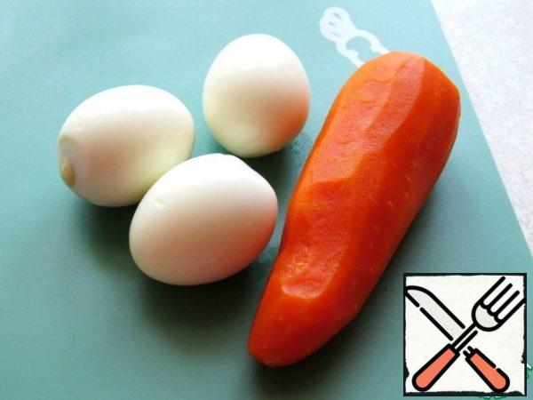 Boil the eggs and carrots: hard-boiled eggs, carrots until ready - and peel.
