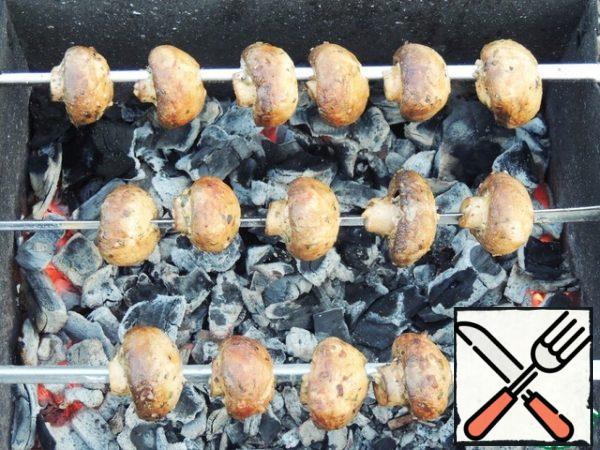String the mushrooms on skewers (sharp corners are better-then the mushrooms will not break and turn over). Cook on coals for 10-15 minutes.
