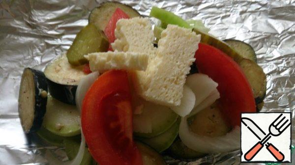 Put the vegetables on a sheet of foil, put on top of a few bars of cheese.