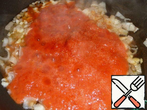 Add the tomatoes to the pan and increase the heat. Add salt, pepper to taste and a pinch of sugar.