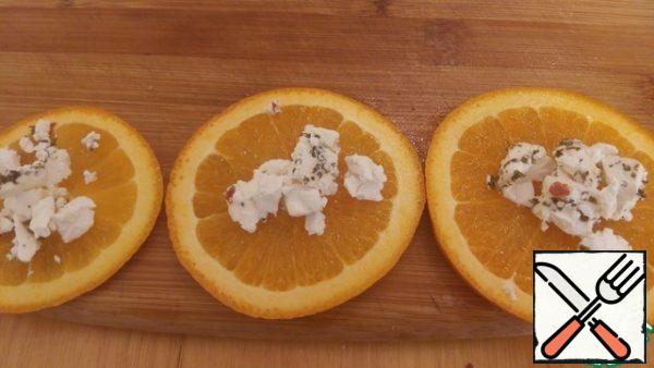 Cut the orange into circles, sprinkle with feta and add to the oven to the pumpkin for 5-10 minutes until ready.