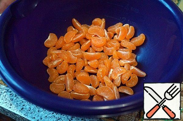 Peel the tangerines and divide them into slices.