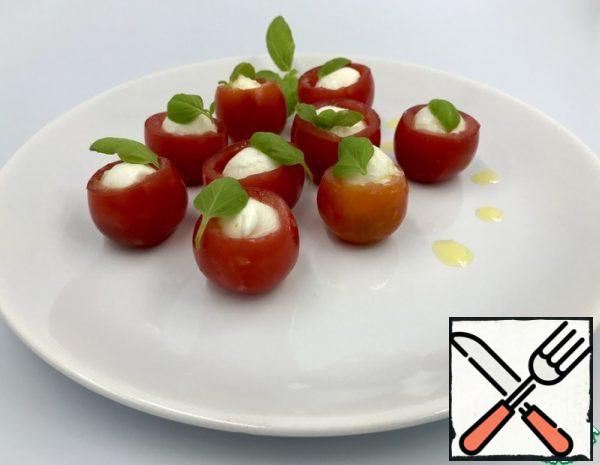 Cut the mozzarella balls in half and dip them in olive oil.
Remove the middle of the cherry tomatoes. In each tomato put a couple of crystals of coarse salt, a drop of balsamic vinegar, a piece of mozzarella. Put a Basil leaf on top. Beautiful, healthy and delicious snack is ready, enjoy!