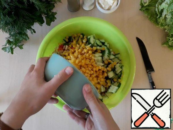 Pour everything into a large container and add the canned corn.