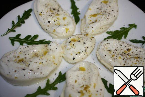 Cut the mozzarella into slices.
Spread each with sour cream, salt and pepper.
Remove the zest from the lemon and also sprinkle on the cheese.
With half a lemon, squeeze out the juice and pour it carefully over each plate.