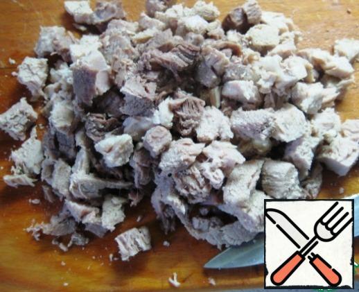 Boil the meat and cut it into small cubes.