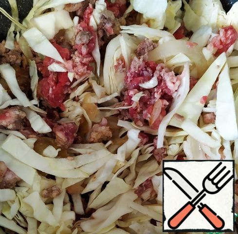 Then add the shredded cabbage. Lightly fry. Turn down the heat on the stove. Add 10 ml. waters. Close the cover. Simmer until tender for 30-40 minutes.