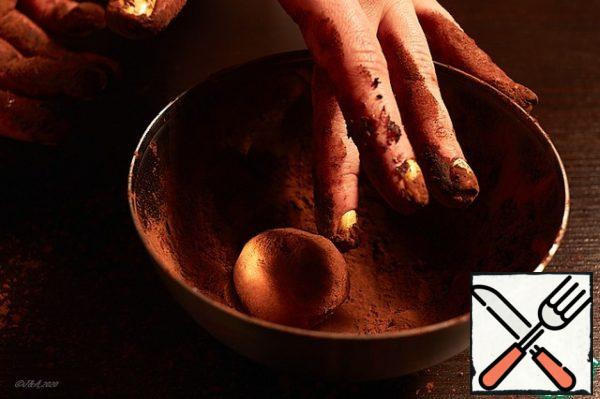 Roll the ball. Roll in a bowl in cocoa powder.