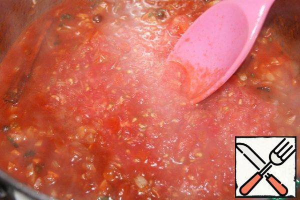 Then add the grated tomatoes and water. Stir, bring to a boil, remove the cinnamon, add the Cayenne pepper and turn down the heat.