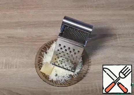 Grate the cheese on a fine grater.