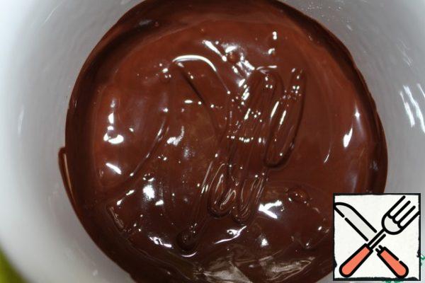 Melt the chocolate broken into small pieces in a water bath or microwave.