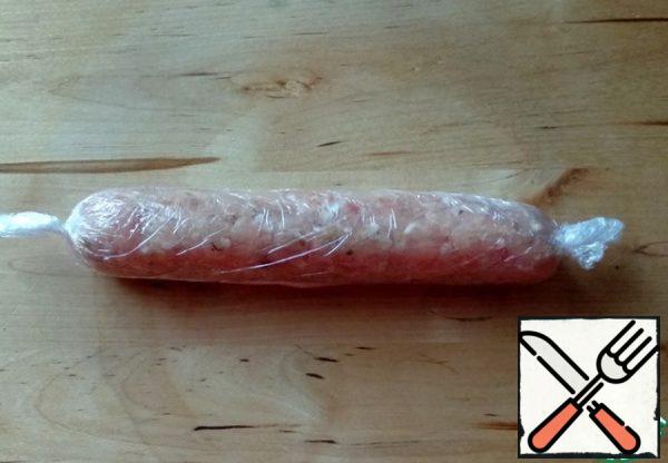 Wrap in plastic wrap. Do the same with the rest of the minced meat and filling.