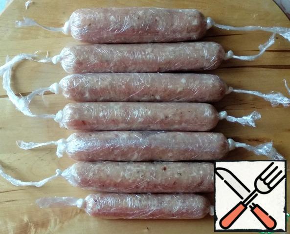 Then wrap each sausage in plastic wrap again (you will get a double layer) and tie tight knots at the edges. I got 6 large sausages and 1 small one.