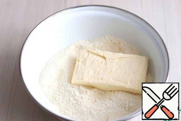 Then add cold butter (150 gr.). chop the mixture into small crumbs, then add cognac (1 tbsp. spoon), add 1 egg. Mix the mixture well. Collect the oil crumbs in a ball, wrap with cling film and place in the refrigerator for 20-30 minutes.
