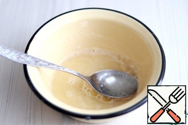 Soak gelatin (10 g) in water (1/4 Cup). Let the mixture stand for a few minutes to swell, then put it on a very low heat and bring the mixture to a boil. Do not boil!