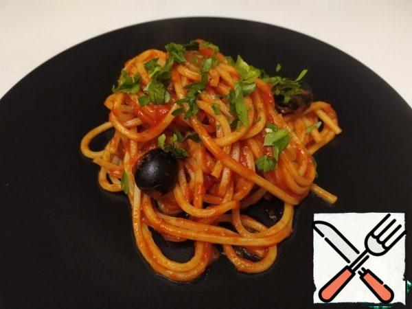 Spaghetti alla puttanesca are ready.Bon appetit.