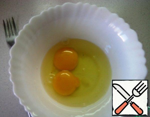 In a separate bowl, beat the eggs with a fork.