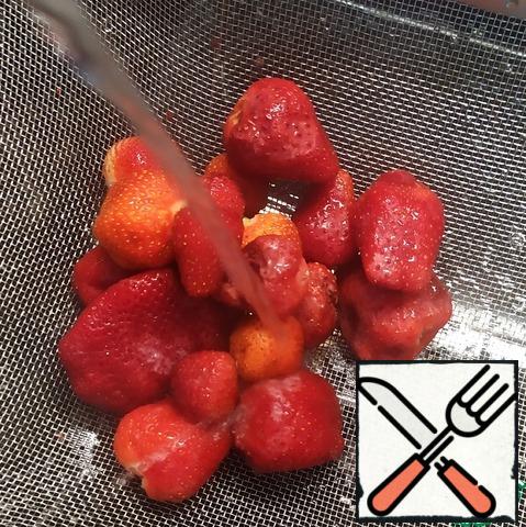 Put the strawberries in a sieve and pour boiling water over them.