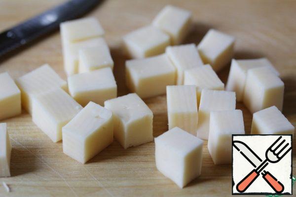 Cut the cheese into cubes.