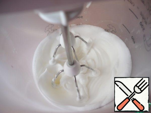 In a large bowl, whisk the whites into a strong foam.