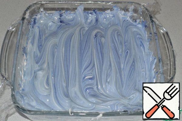 With a spatula, stir the syrup into the marshmallow, creating marble streaks.