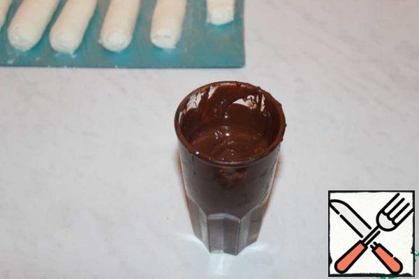 Melt the chocolate in a tall glass.