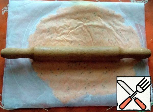 Cover the top with another sheet of parchment and roll out with a rolling pin, approximately 3-4 mm thick.