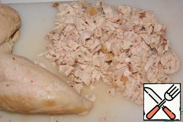 Boil the chicken fillet with your favorite spices. Cool and cut into small pieces.
