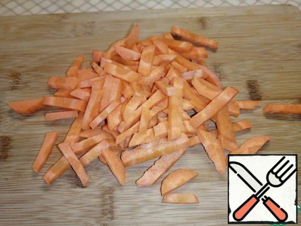 Cut the carrots into long strips.