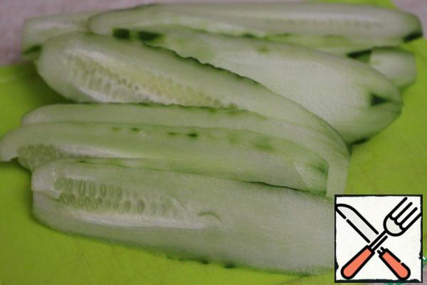 Peel the cucumbers and slice them lengthwise.