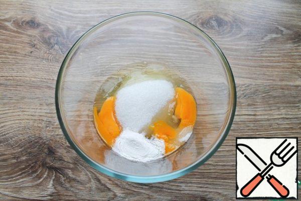 In a bowl, break the eggs, add sugar, baking powder and vanilla.