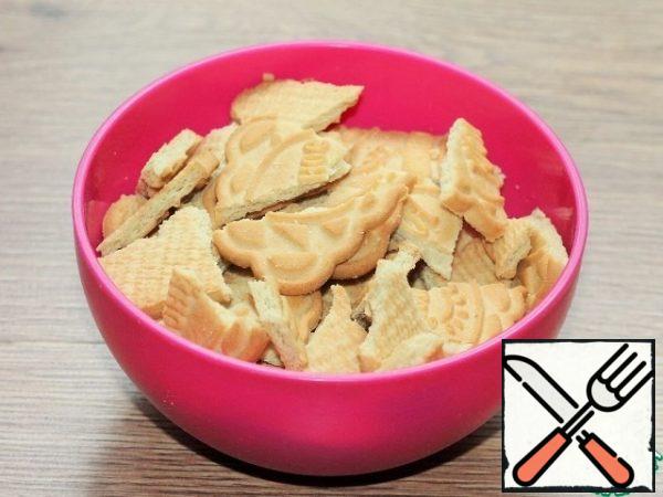 Put the cookies in a bowl and break or chop them with a rolling pin.