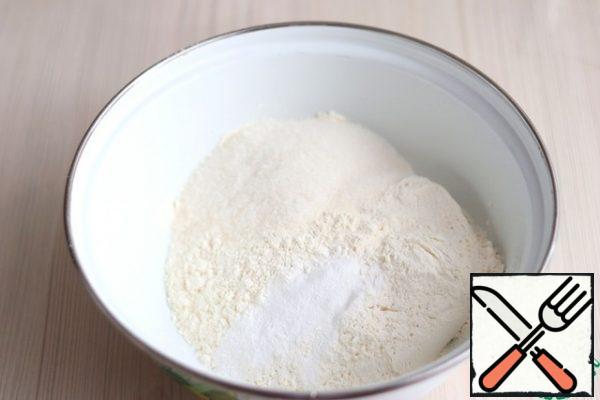 In a bowl, add flour (250 gr.), sugar (80 gr.) and baking powder (1/2 tsp.). The mixture is stirred.