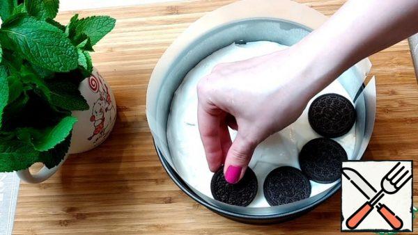 Put half of the ice cream on the base, put a row of Oreos with mint, put the second half on top.