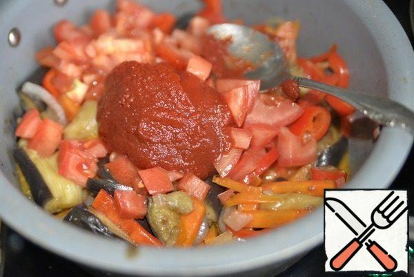 Put the tomato in a pan with the vegetables, add the tomato paste. Stir and simmer for five minutes.