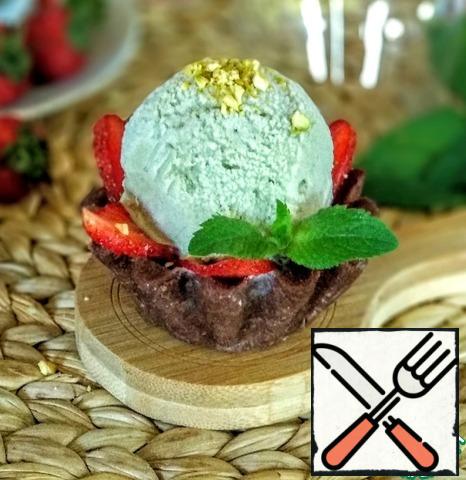 Put mint ice cream balls on top of the strawberries.