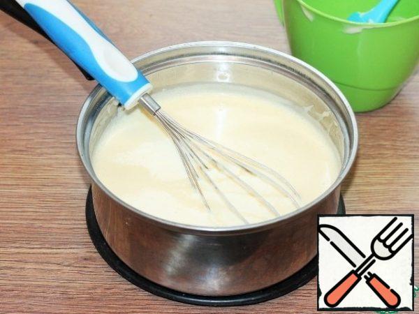 Gradually stir the yolks into the hot milk mixture, stirring quickly and avoiding curdling.