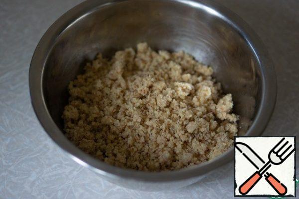 Mix the crushed almonds, sugar and flour. Add the diced butter. RUB your hands into a crumb. Place in the refrigerator before use.