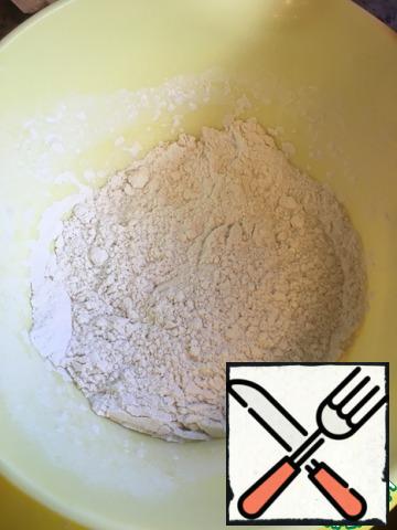 In a separate bowl, stir the flour with the baking powder.