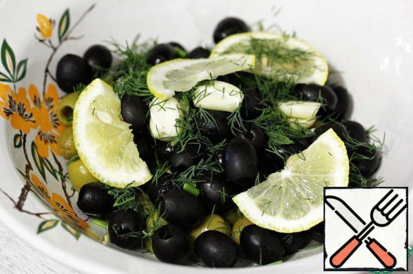 Put the olives in a deep bowl, add the dill, garlic and lemons.